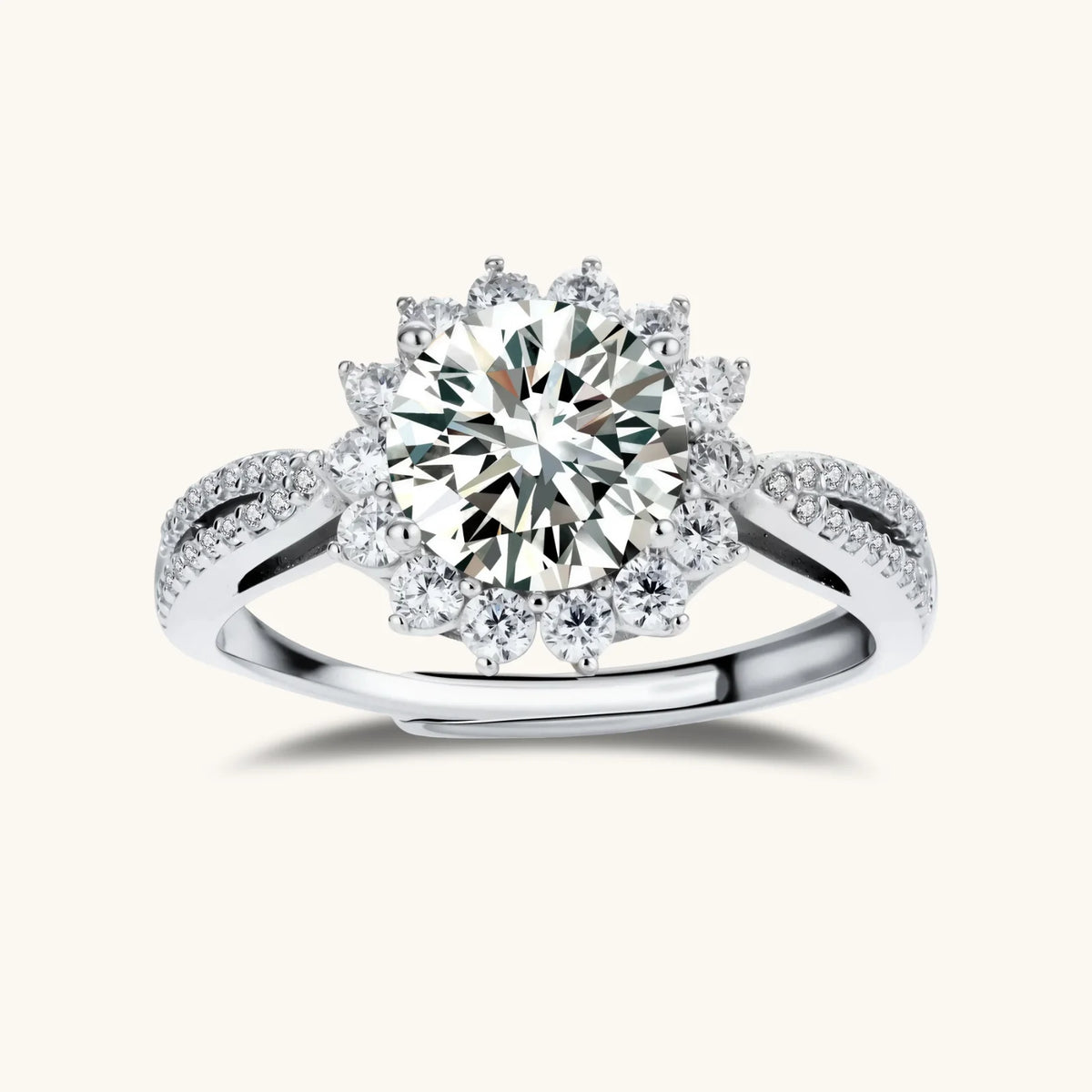 close-up of sterling silver halo ring with brilliant round moissanite center stone surrounded by smaller accent stones