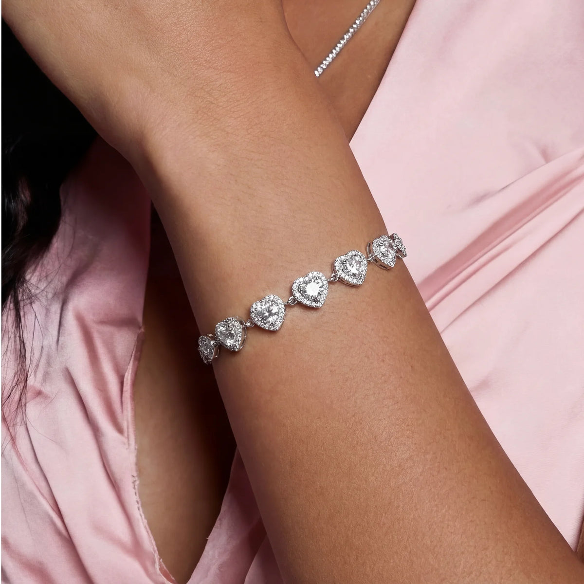 complete jewelry set with heart-shaped sterling silver pieces featuring brilliant moissanite stones on white background.