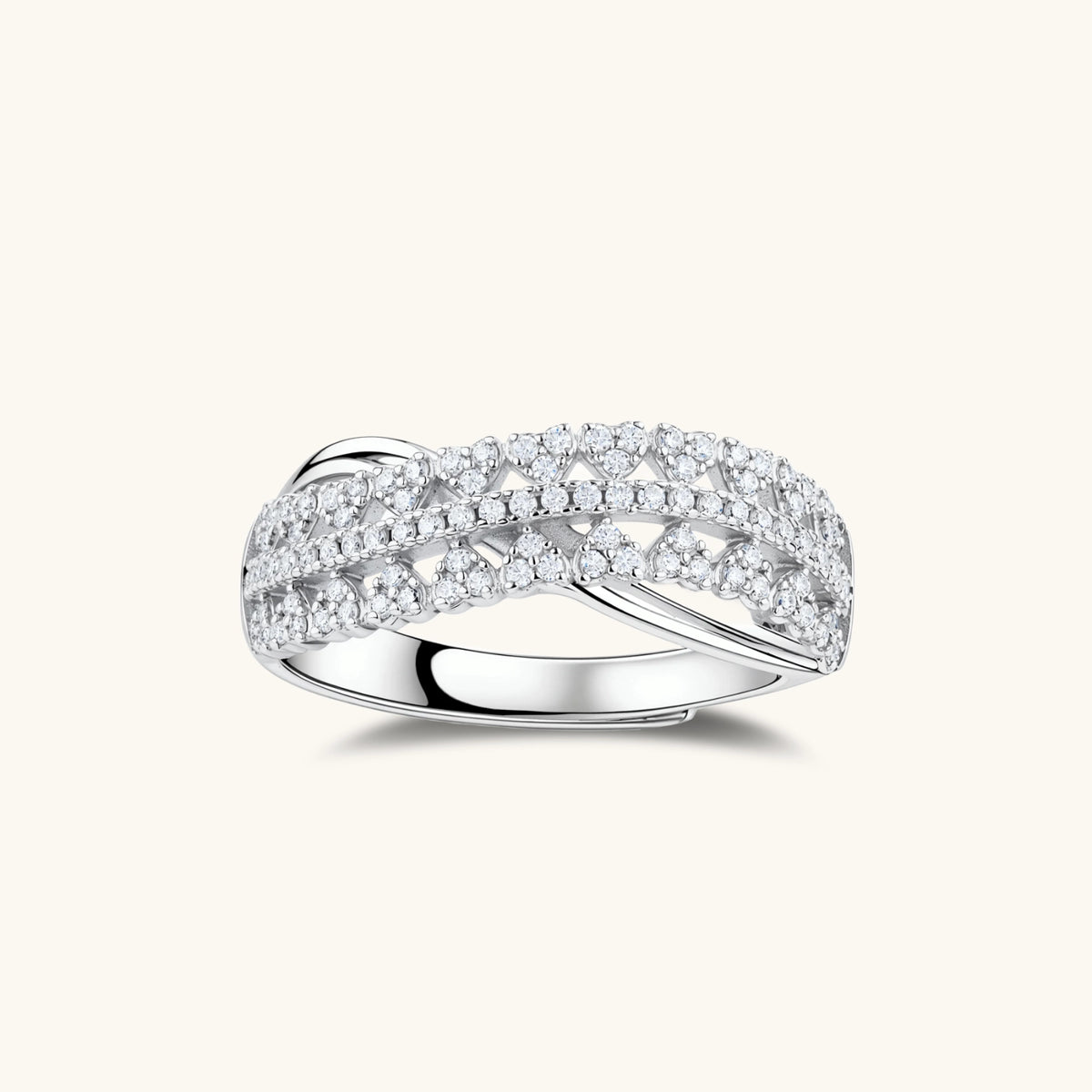 sterling silver crossover ring with pavé-set moissanite stones creating an elegant infinity design on neutral background