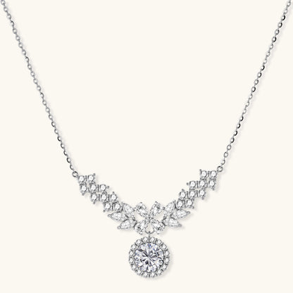 Elegant sterling silver necklace featuring intricate wing-like design with brilliant moissanite stones on neutral background.