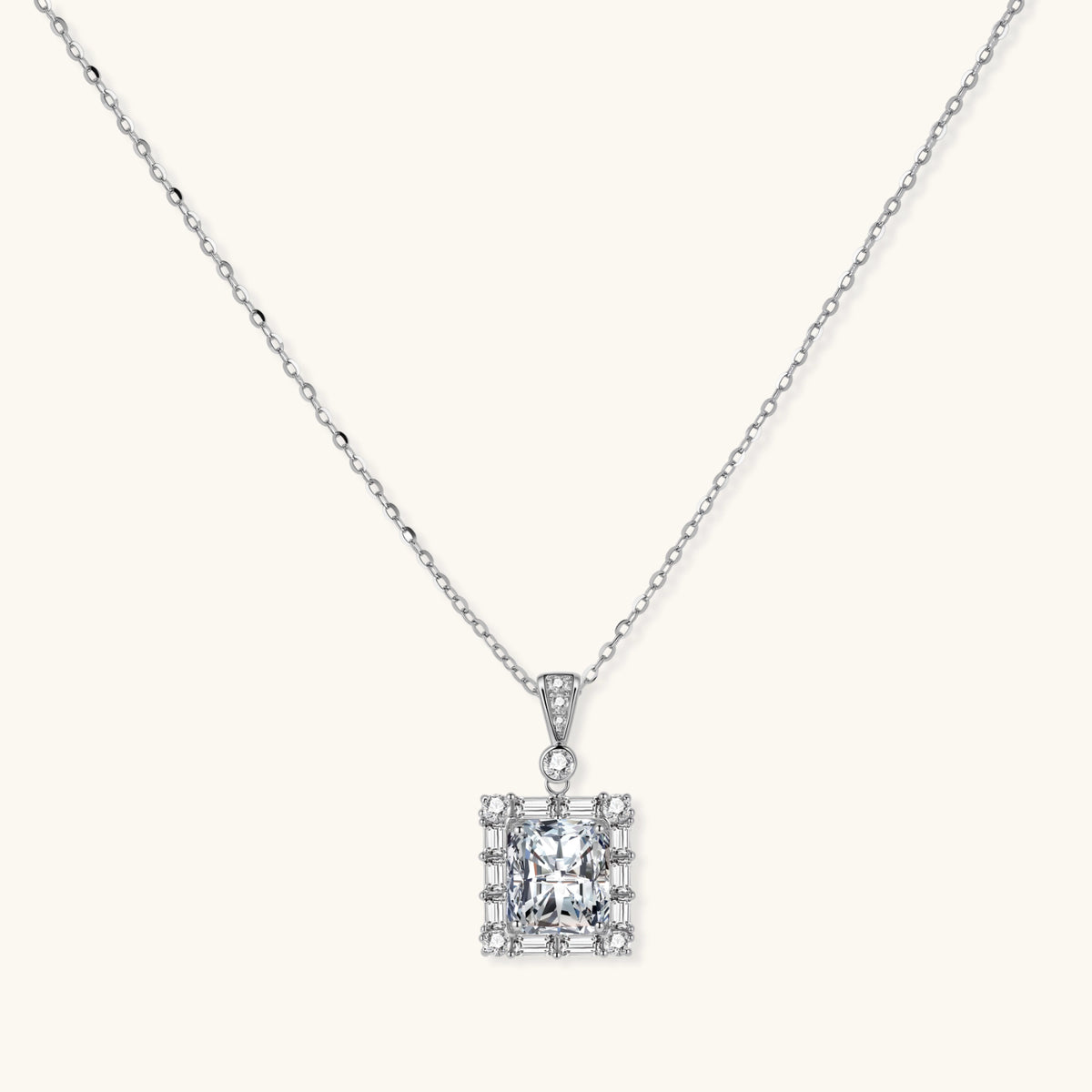 square moissanite pendant with halo setting on delicate sterling silver chain against white background.