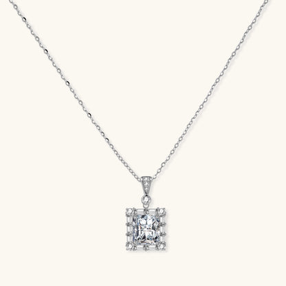 Square moissanite pendant with halo setting on delicate sterling silver chain against white background.