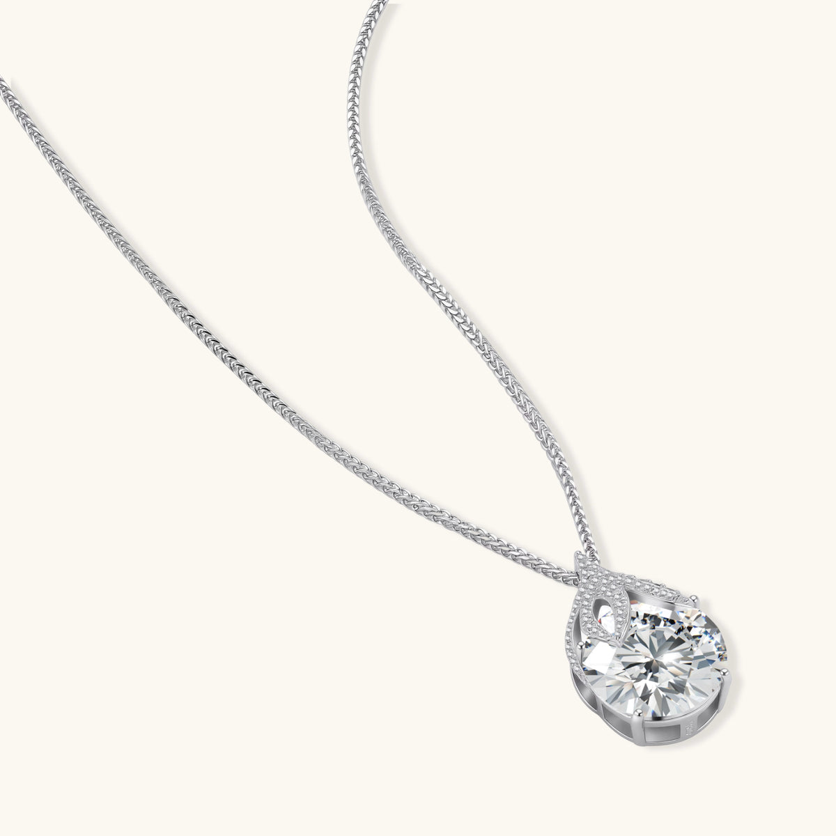 sterling silver necklace featuring a large pear-shaped moissanite stone in an ornate setting with smaller accent stones