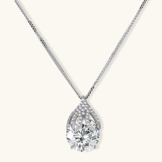Sterling silver necklace featuring a large pear-shaped moissanite stone in an ornate setting with smaller accent stones
