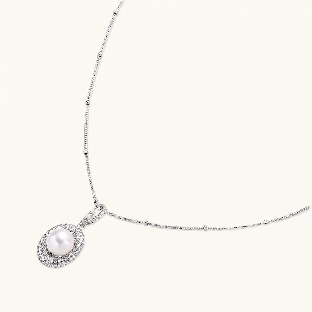 oval sterling silver pendant with crystal halo surrounding a white freshwater pearl on delicate chain