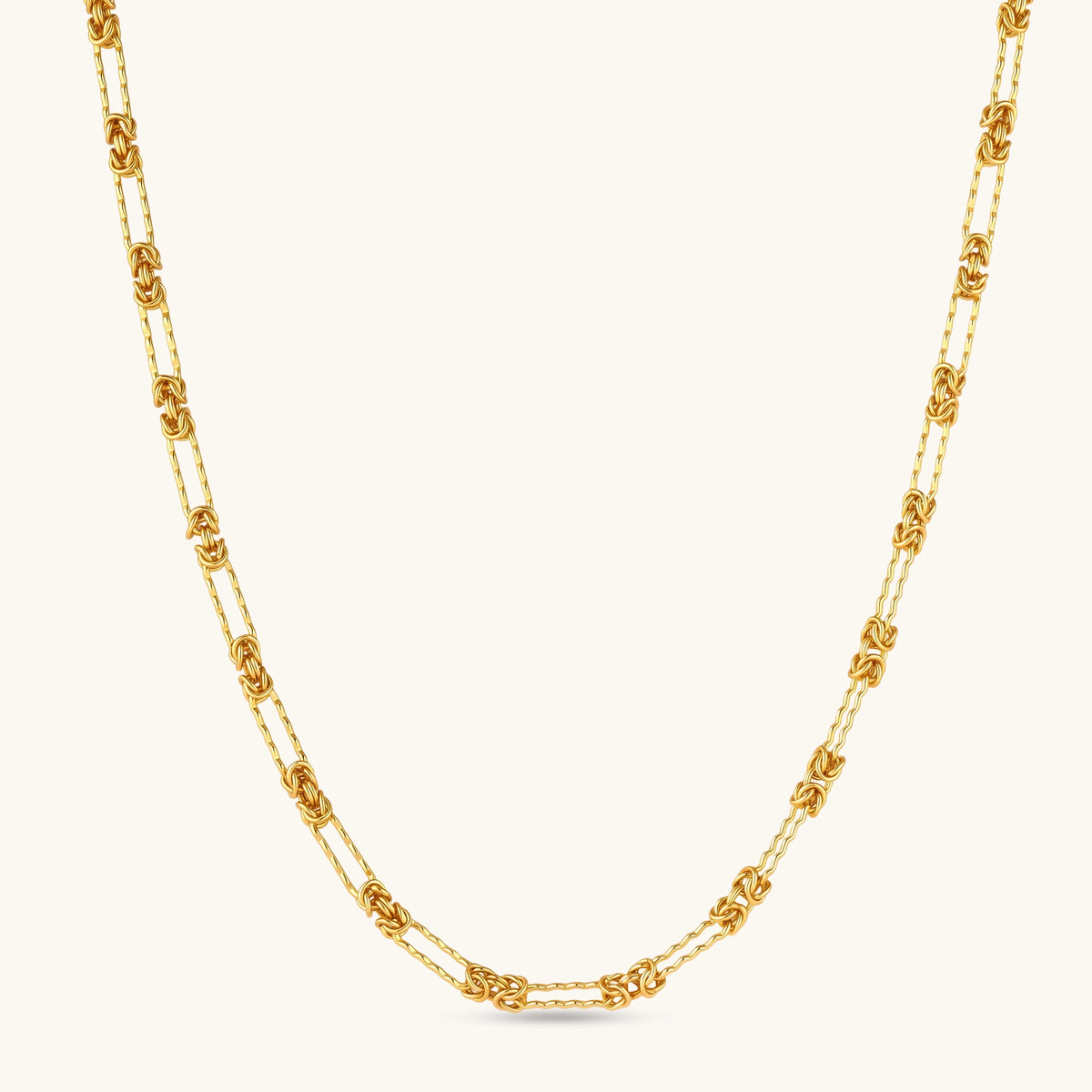 gold-plated sterling silver chain necklace with alternating love-knot links and elongated oval links, lobster clasp closure.