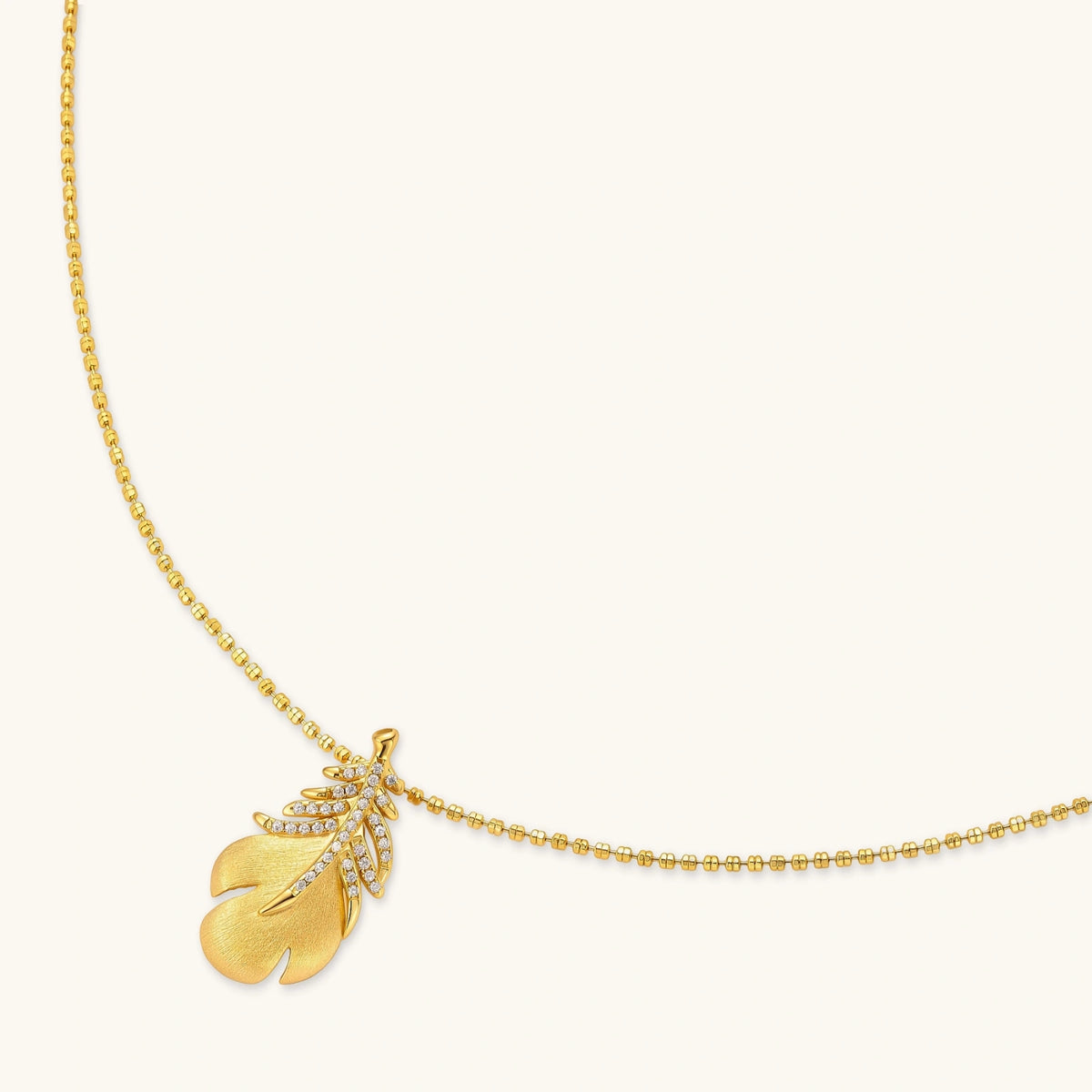 18k gold-plated 925 silver leaf pendant with brushed finish and cubic zirconia accents on a beaded ball chain.