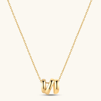 18K gold-plated 925 sterling silver letter N pendant on a delicate adjustable cable chain, cream background.