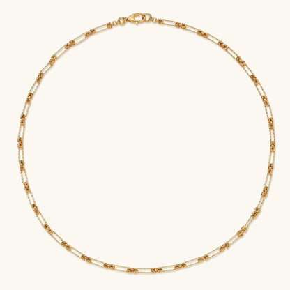 Gold-plated sterling silver chain necklace with alternating love-knot links and elongated oval links, lobster clasp closure.